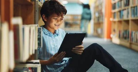 Learning, student and tablet with boy in library for back to school development, Stock Photos