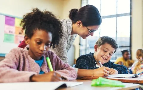 Learning, teacher and help kid in classroom for education support, developm.. Stock Photos