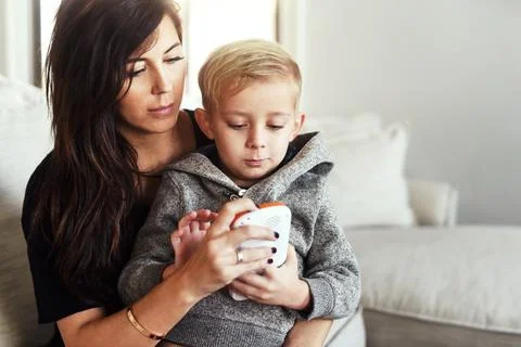 Learning technology on a early age. a carefree young woman browsing on a Stock Photos
