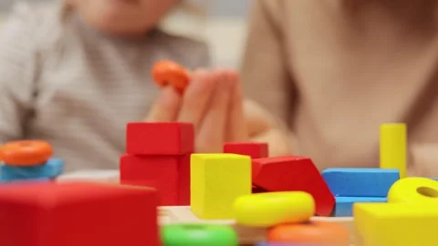 Learning through play. Colorful shape sorter. Cooperative play activities. Stockbeeldmateriaal 256290657
