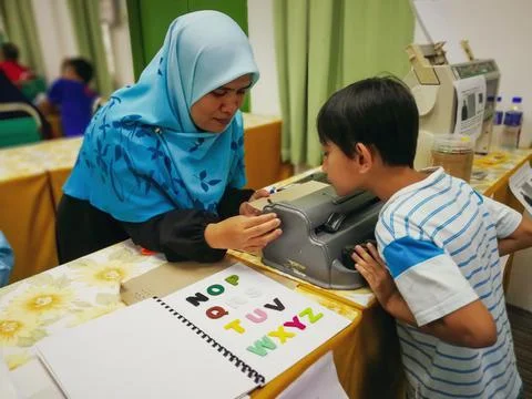 Learning to use the braille typewriter. 写真素材