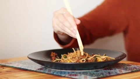 Learning to Use Chopsticks. A Difficult but Fun Challenge. chinese food con.. Stock Footage 317079203