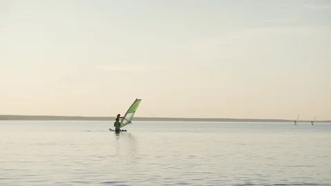 Learning windsurfing on the lake. Stock Footage 93904038