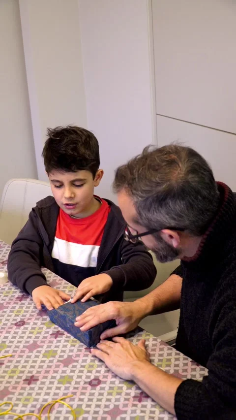 Learning to wrap Christmas of birthday presents 스톡 동영상 345253828
