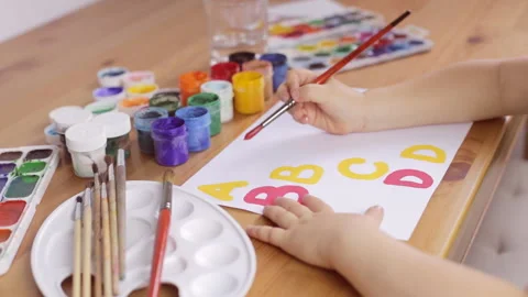 Learning to write letters on a white sheet of paper Stock Footage 92839108