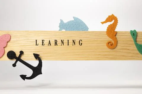 Learning written on wood patterned surface. Education and child psychology Stock Photos