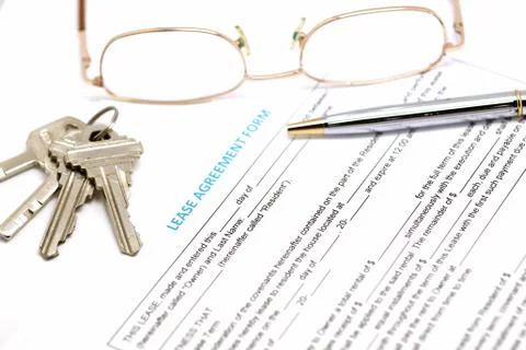 Lease agreement document with key Stock Photos