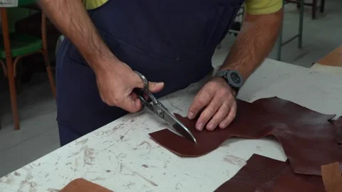 Leather Artisan Cutting a Piece with Scissors in the Workshop - 861 Stock Footage 308818136