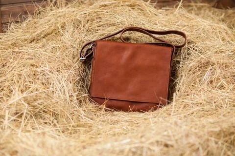 Leather bag in the hay Stock Photos