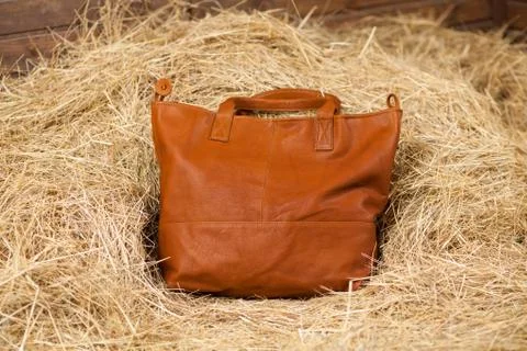 Leather bag in the hay Stock Photos