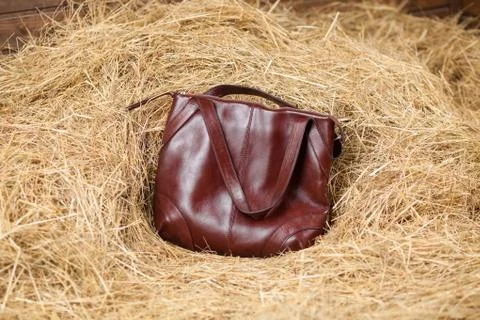 Leather bag in the hay Stock Photos