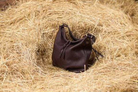 Leather bag in the hay Stock Photos