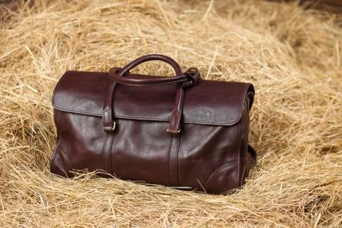 Leather bag in the hay Stock Photos