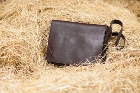 Leather bag in hay Stock Photos