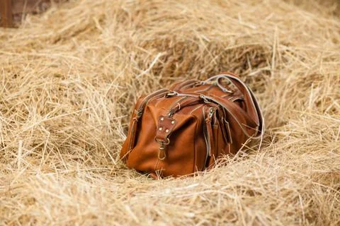 Leather bag in the hay Stock Photos