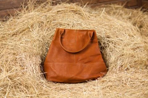 Leather bag in the hay Stock Photos