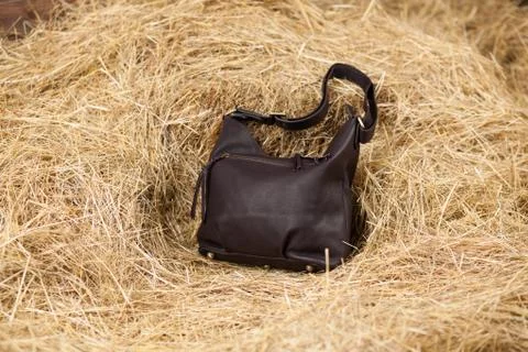 Leather bag in the hay Stock Photos