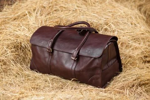 Leather bag in the hay Stock Photos