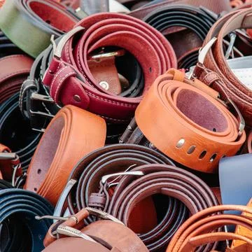 Leather belts piled in bulk Stock Photos
