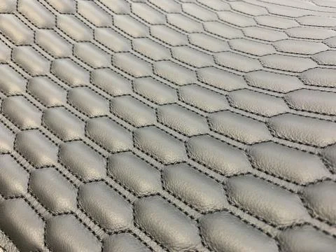 Leather black stitched with pattern honeycomb Stock Photos