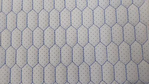 Leather blue stitched with perforated pattern honeycomb Stock Photos