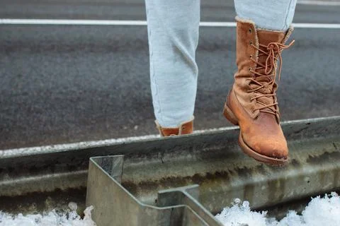 Leather boot on the side of the road stop before a long journey. A long walk in Stock Photos