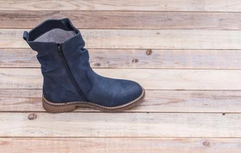 Leather boot at wood background Stock Photos