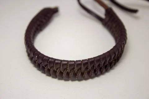 Leather bracelet, braided in a beautiful pattern, with straps to fasten on th Foto stock