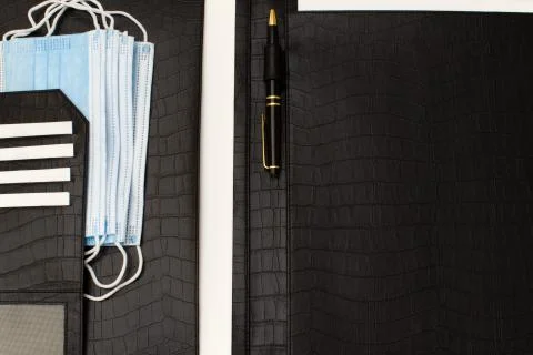 Leather business folder with a set of essential antivirus masks Stock Photos