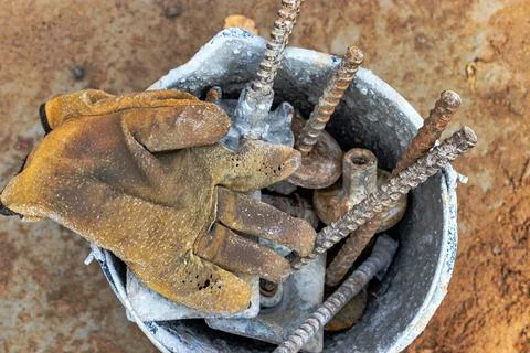 Leather construction gloves on the concrete surface of the foundation. Old wo Stock Photos