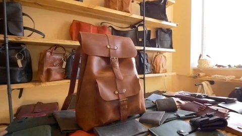 Leather craft handmade backpack in showroom Stock Footage 118136152