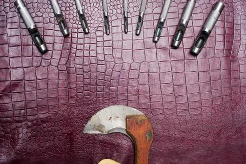 Leather craft tools on a leather background. Craftsman work desk . Piece of.. Stock Photos