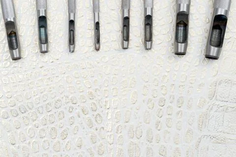 Leather craft tools on a leather background. Craftsman work desk Stock Photos
