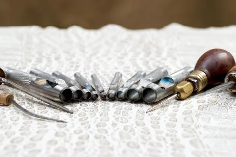 Leather craft tools on a leather background. Craftsman work desk Stock Photos