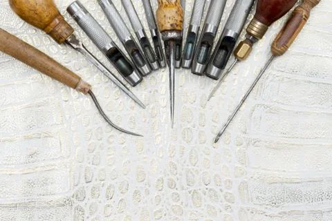 Leather craft tools on a leather background. Craftsman work desk Stock Photos