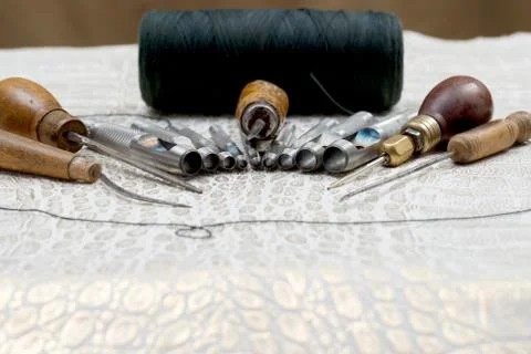 Leather craft tools on a leather background. Craftsman work desk Stock Photos