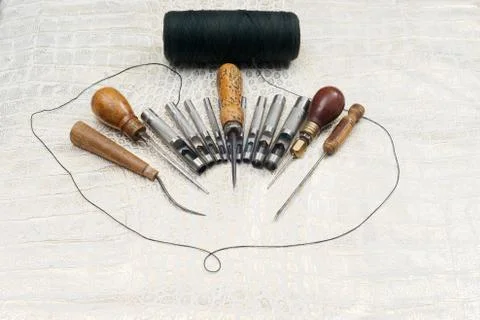 Leather craft tools on a leather background. Craftsman work desk Stock Photos