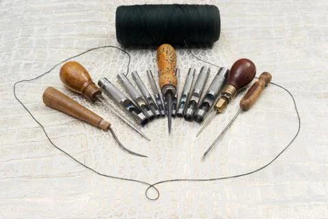 Leather craft tools on a leather background. Craftsman work desk Stock Photos