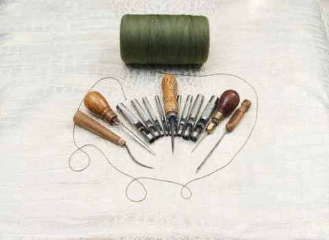 Leather craft tools on a leather background Stock Photos