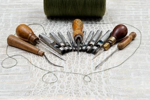 Leather craft tools on a leather background. Craftsman work desk Stock Photos
