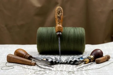 Leather craft tools on a leather background. Craftsman work desk Stock Photos