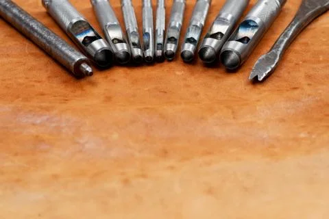 Leather craft tools on a leather background. Craftsman work desk Stock Photos