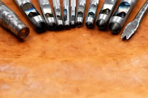 Leather craft tools on a leather background. Craftsman work desk Stock Photos