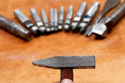 Leather craft tools on a leather background. Craftsman work desk Stock Photos