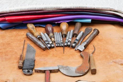 Leather craft tools on a leather background. Craftsman work desk Stock Photos