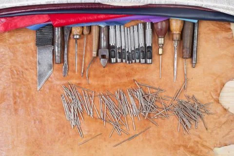 Leather craft tools on a leather background. Craftsman work desk Stock Photos