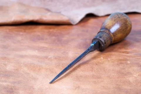 Leather craft tools on a leather background. Craftsman work desk Stock Photos