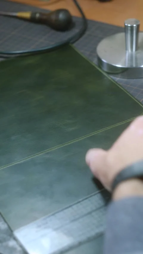 Leather craftsman cutting leather for project Stock Footage 296552090