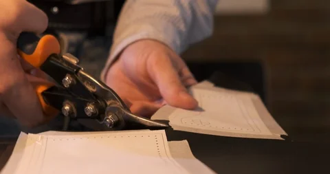 Leather Craftsman with Scissors Cuts Leather along Template on Desktop, Tanner Stock Footage 129566306