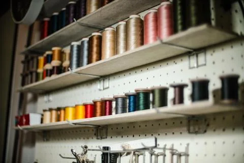 Leather craftsman threads and tools for leather works collected on shelf Stock Photos